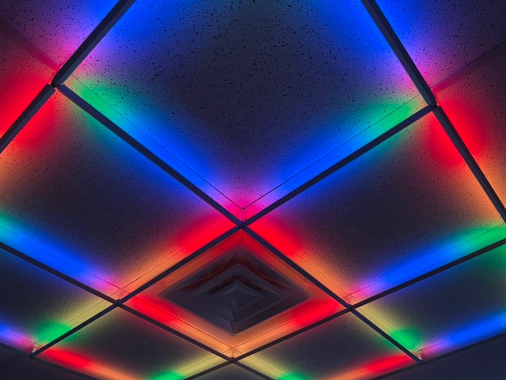 Overhead view of a GridLights 2×2 lightbar grid lit in red, green, blue, and white.